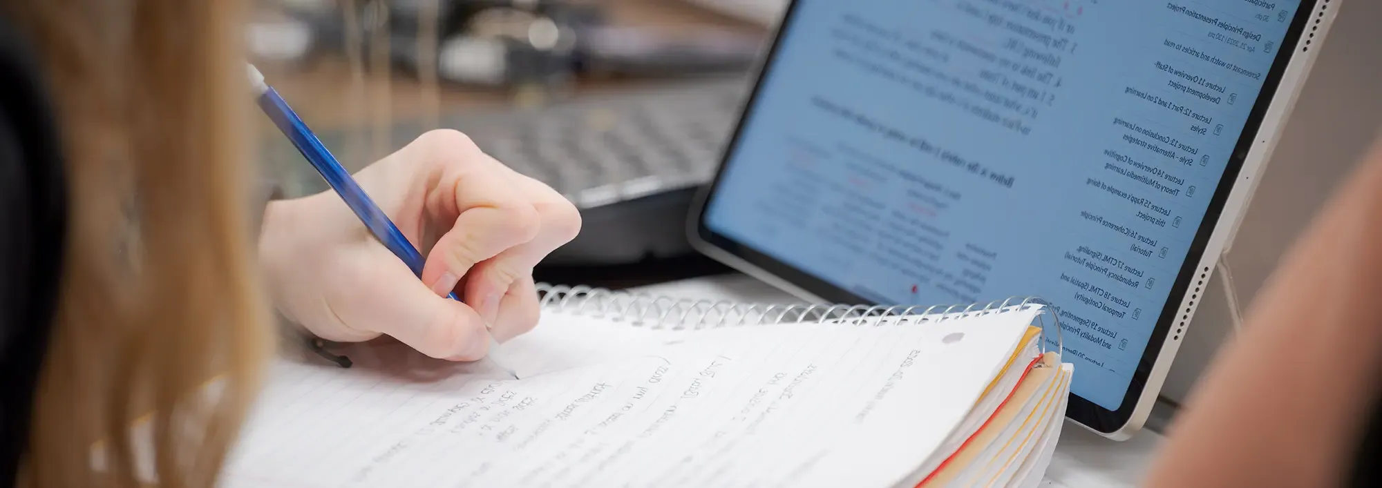 Closeup of a student's hands working with a laptop